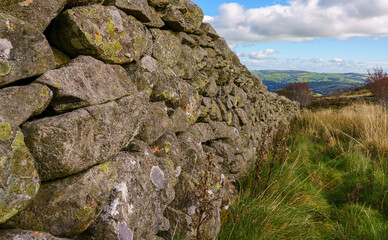 close up of a dry stone wall under a vivid blue sky on a mountain top in north wales