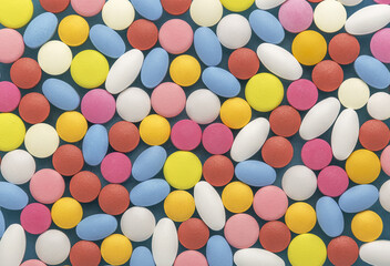 Heap of medical pills in white, blue and other colors.  Concept of healthcare and medicine.