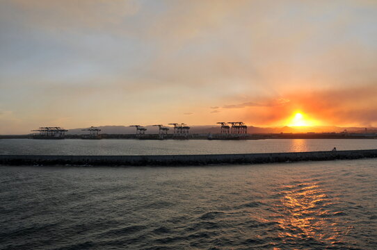 Cargo cranes in the sunset