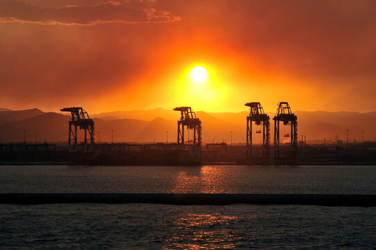 Cargo cranes in the sunset
