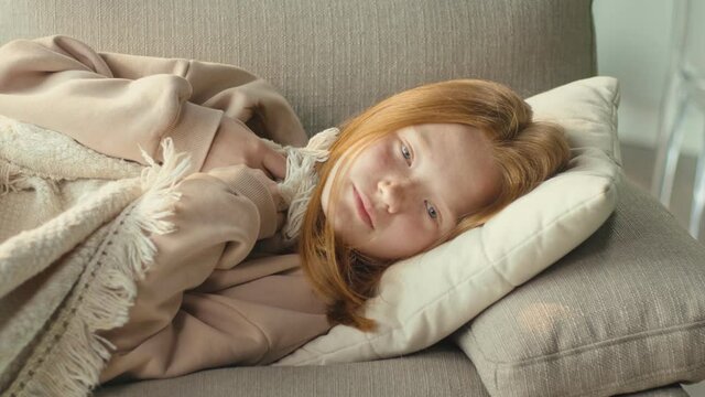 The Depressed Red-haired Girl is Sad Alone in the Living Room of the House. Mental Health Concepts, Bullying, Depression, and Anxiety. Mental Health.