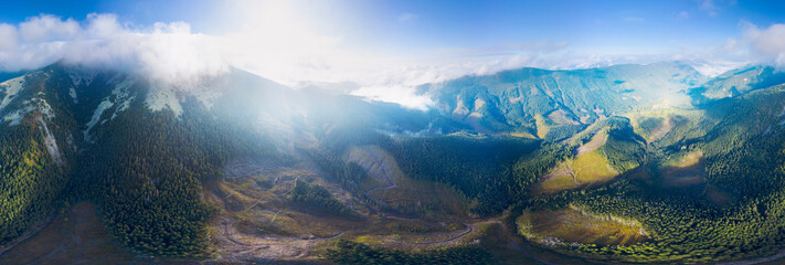 Fototapeta na wymiar Flight over the misty mountain Syvulya