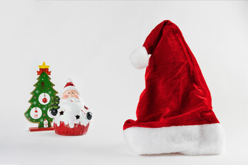 Santa's cap and Santa Claus isolated on white background. Christmas ornament. Selective focus.