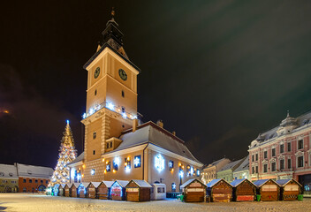 Christmas Tree in the old city center of Brasov in a snowing night,Panoramic view of the old town...