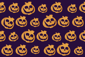 Seamless Halloween pattern. Pumpkin face on a dark purple background. Flat lay