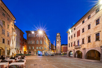 Fototapeta premium View of the beautiful Riva del Garda town by night, Lake Garda surrounded by mountains in the summer, Italy