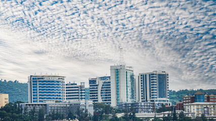 Landscape of modern office buildings under a blue cloudy sky in Kigali, Rwanda