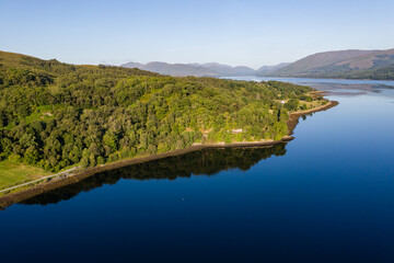 Fototapeta na wymiar Aerial view of a tranquil Scottish loch in the early morning sunshine (Loch Eil, Fort William)