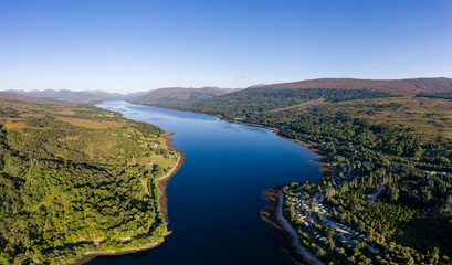 Aerial view of a tranquil Scottish loch in the early morning sunshine (Loch Eil, Fort William)