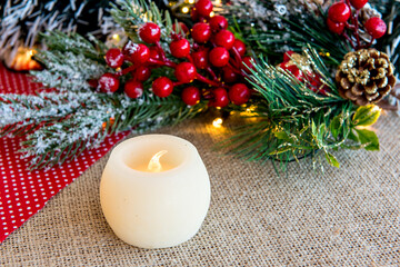 Candles on a Christmas table with Christmas ornaments