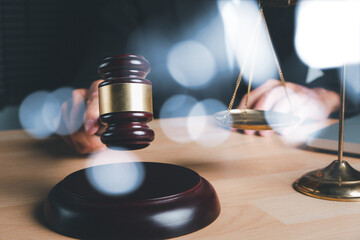 Male judge in a courtroom with the gavel on office desk, terrorism, crime, judgment, verdict, justice and law concept