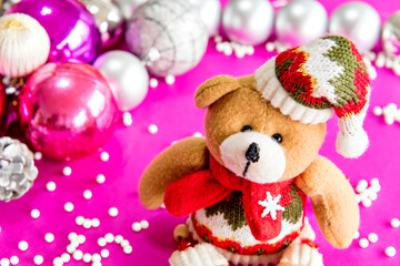 Christmas bear in Christmas decoration with pink background.