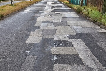 Obraz premium Patched broken road