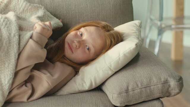 The Depressed Red-haired Girl is Sad Alone in the Living Room of the House. Mental Health Concepts, Bullying, Depression, and Anxiety. Mental Health.