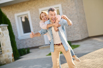 Husband and wife rejoicing at keys to new home