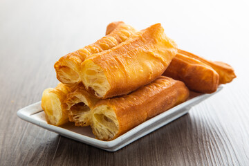 Youtiao.  Long golden brown deep fried dough strip.