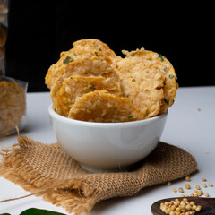 Kripik tempe, indonesian crackers food, decorated with spoon and lime leaves