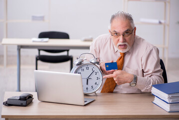 Old male employee in time management concept