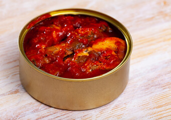 Opened tin can of sprat fish roasted in tomato sauce