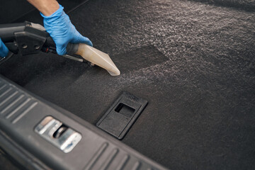 Detailing and cleaning car with vacuum cleaner