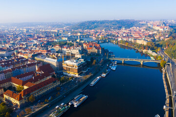 Aerial view of modern Prague cityscape overlooking bridges over Vltava river on sunny autumn day, Czech Republic