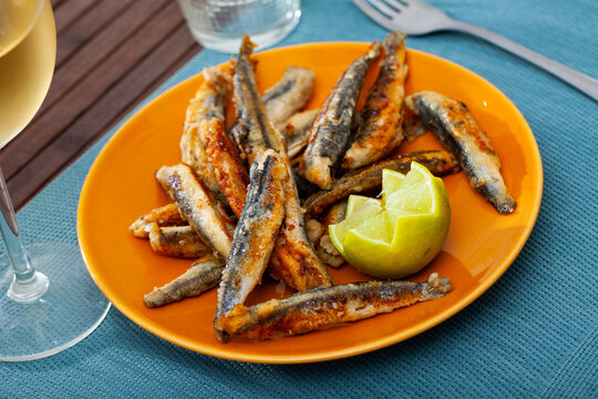 Appetizer cooked fried anchovies with lemon, Spanish cuisine