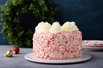 Peppermint bark and chocolate cake for Christmas on a festive background