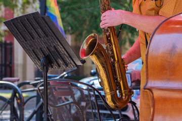 Hands Playing Saxophone and Music Stand 