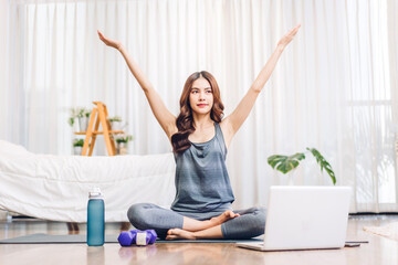 Portrait sport asian beauty body slim woman in sportswear sitting relax and girl practicing yoga and do fitness exercise with laptop computer in bedroom at home.Diet concept.Fitness and healthy