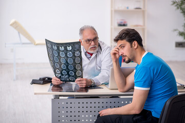 Young male patient visiting old male doctor radiologist