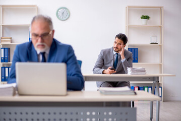 Two male colleagues working in the office