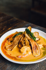 Thai Spicy Curried Prawns with coconut milk curry, lime leaf, banana chips
