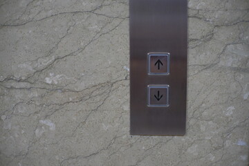 The button that gives directions to go up and down the elevator.
