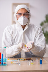 Young male chemist in vaccination concept during pandemic