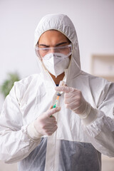 Young male chemist in vaccination concept during pandemic