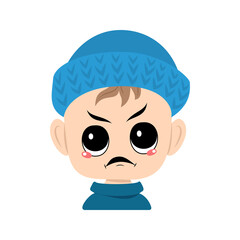 Boy with emotions panic, surprised face, shocked eyes in blue knitted hat. Cute kid with scared expression in autumnal or winter headdress. Head of adorable toddler