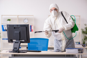 Naklejka premium Old male contractor in office disinfection concept