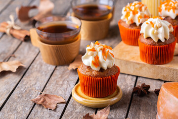 Homemade autumn pumpkin cupcakes or muffins with nuts and spices