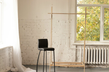Photo studio in a large, bright room with large windows.