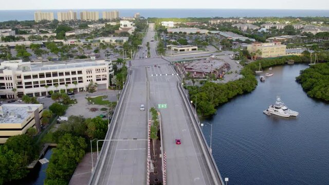 Aerial drone view overlooking a calm highway in sunny, Jupiter, Florida, USA