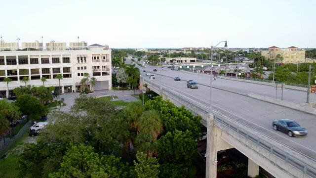 Aerial view of traffic on a bridge, freeway 706, in Jupiter, Florida - reverse, drone shot