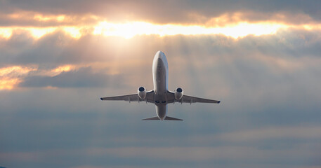 Fototapeta na wymiar Airplane in the sky at amazing sunset