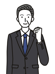 ガッツポーズのスーツを着たシニア男性