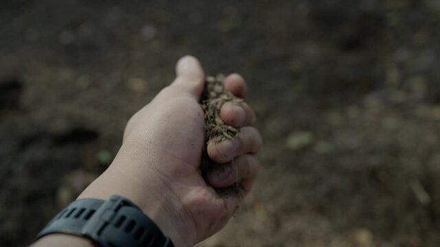 slow motion Human hand holding soil 