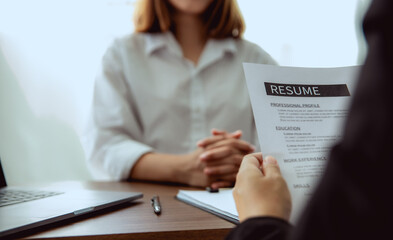 A woman submit a resume to boss for apply to work in company.