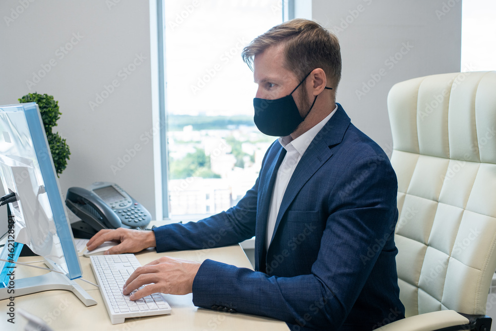 Poster young caucasian white collar worker working in front of computer in office