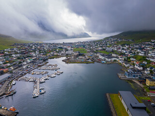 Beautiful aerial view of the City of Klaksvik in the Fareo Islands with its colorful houses and...