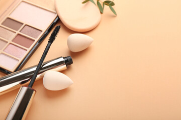 Stylish makeup sponges and decorative cosmetics on color background