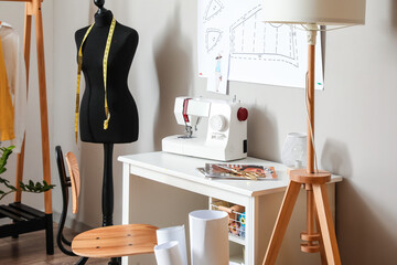 Tailor's workplace with mannequin in modern atelier