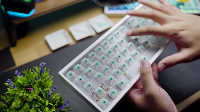 Footage of a person testing the acoustic sound from custom build mechanical DIY keyboard.